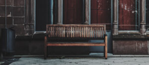 brown bench in front of window